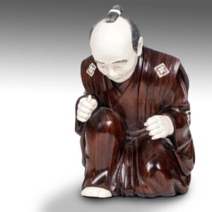 Japanese Signed Carved Okimono of Kneeling Male with Robe and Inlaid Flowers